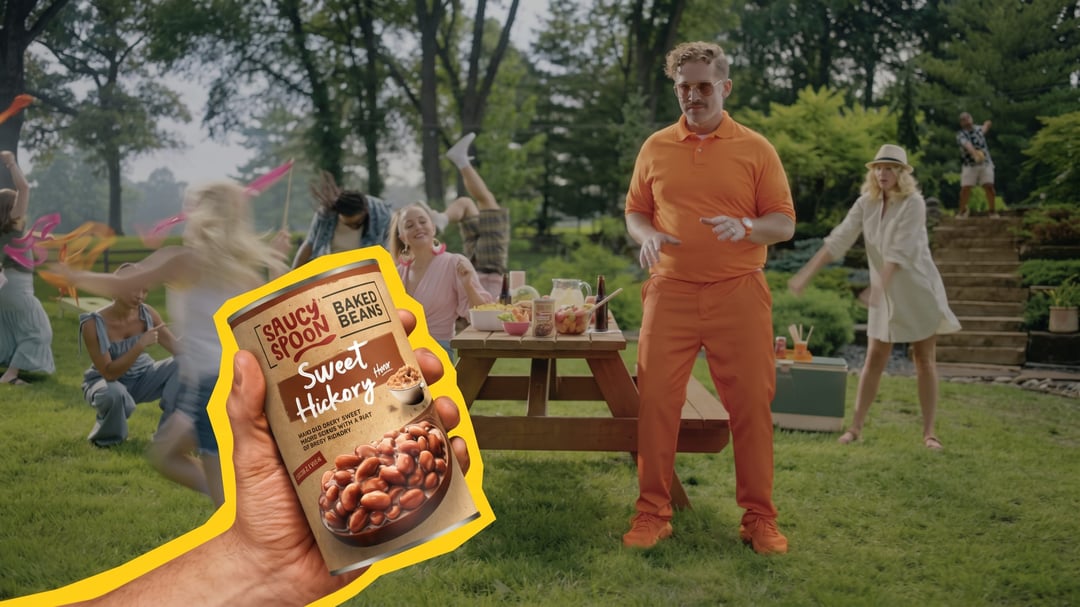 Saucy Spoon Baked Beans can at a summer picnic spread